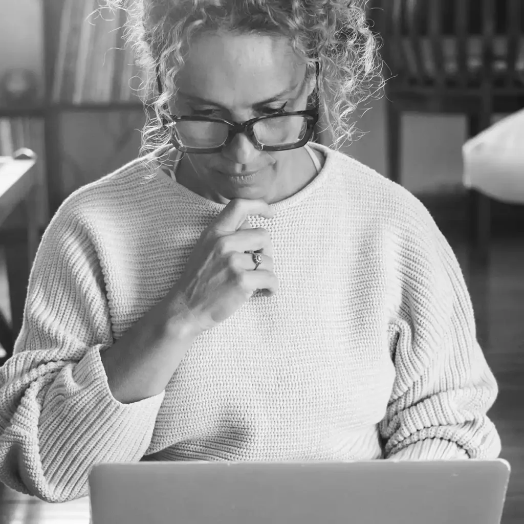 Woman reviewing financial information on laptop during a period of life transition
