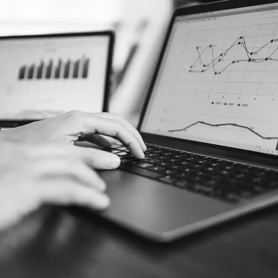 Laptop computer on desk displaying charts and data